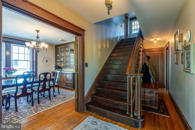 466 E Main St, Leola, PA 17540 - staircase featuring wood finished floors, a chandelier, and baseboards