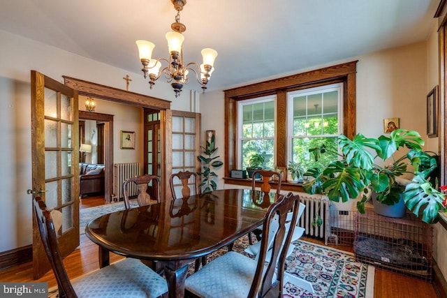 466 E Main St, Leola, PA 17540 - dining area with french doors, wood finished floors, radiator heating unit, and a chandelier