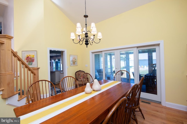 4906 Timbermarsh Ln, Woolford, MD 21677 - dining room featuring high vaulted ceiling, french doors, a chandelier, wood finished floors, and stairway
