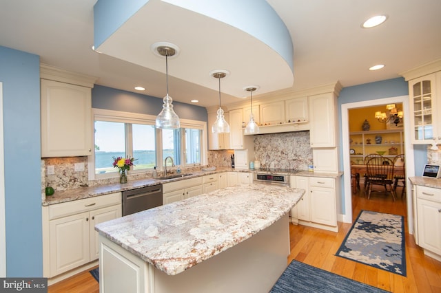 4906 Timbermarsh Ln, Woolford, MD 21677 - kitchen with appliances with stainless steel finishes, a sink, a center island, light wood-style floors, and light stone counters