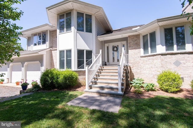 4906 Timbermarsh Ln, Woolford, MD 21677 - view of front facade with a front lawn, a garage, and brick siding