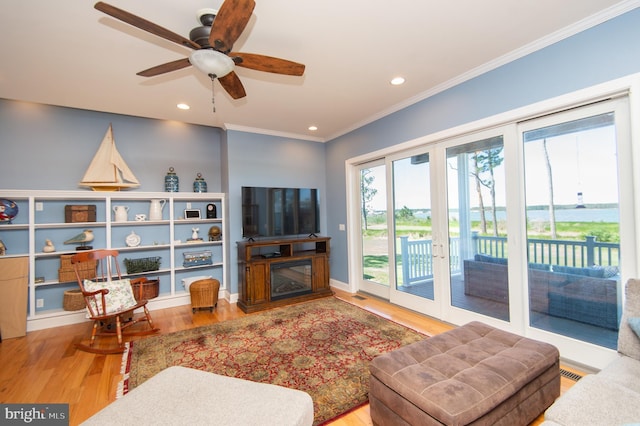4906 Timbermarsh Ln, Woolford, MD 21677 - living area with wood finished floors, crown molding, recessed lighting, a ceiling fan, and a glass covered fireplace