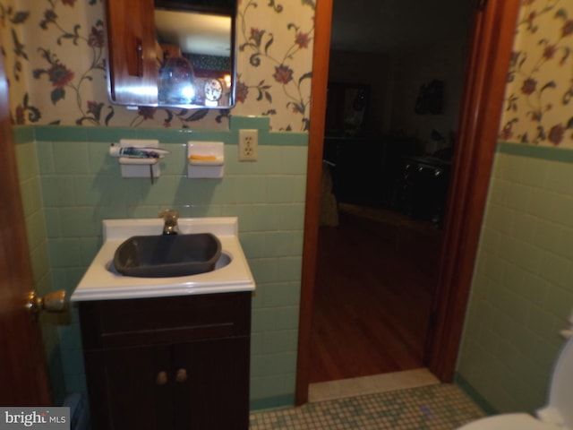2713 Rowe Rd, New Windsor, MD 21776 - bathroom with wallpapered walls, tile walls, a wainscoted wall, vanity, and tile patterned flooring