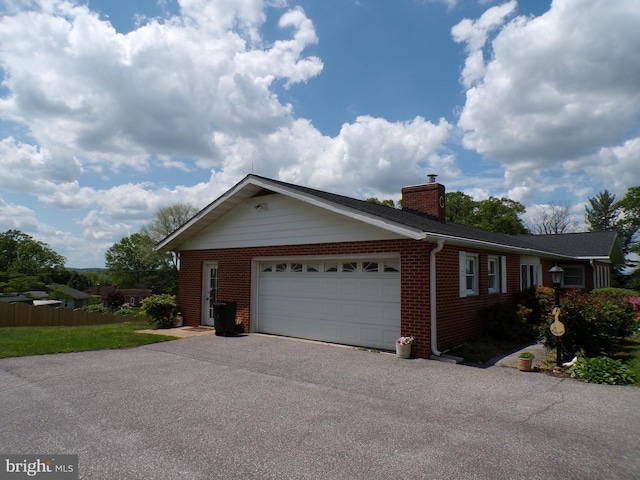 2713 Rowe Rd, New Windsor, MD 21776 - view of front of property featuring driveway, brick siding, a chimney, and an attached garage