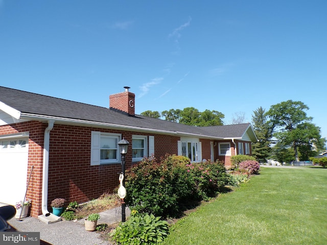 2713 Rowe Rd, New Windsor, MD 21776 - view of side of home featuring brick siding, a chimney, a yard, and an attached garage