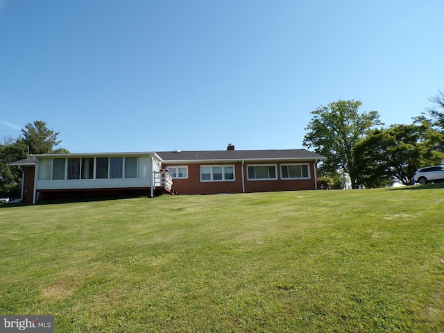 2713 Rowe Rd, New Windsor, MD 21776 - view of front of house featuring brick siding, a front lawn, a sunroom, and a chimney