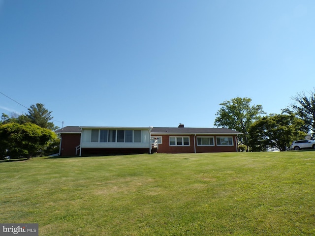 2713 Rowe Rd, New Windsor, MD 21776 - ranch-style house with a front lawn, a sunroom, a chimney, and brick siding
