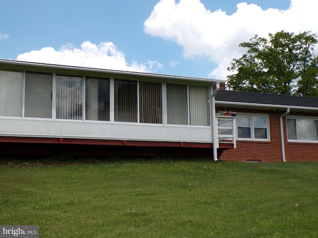 2713 Rowe Rd, New Windsor, MD 21776 - view of side of property featuring a lawn, a sunroom, and brick siding