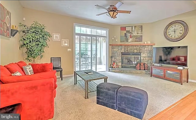 554 Pinecrest Dr, Pocono Pines, PA 18350 - carpeted living area featuring ceiling fan, baseboards, and a stone fireplace