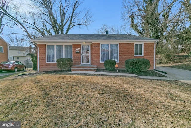 view of front of house with a front yard and brick siding