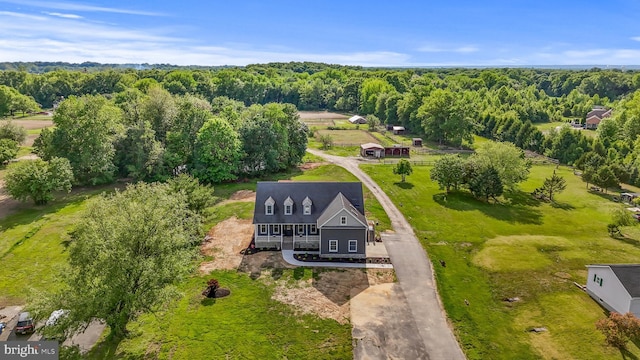 view of subject property featuring a forest