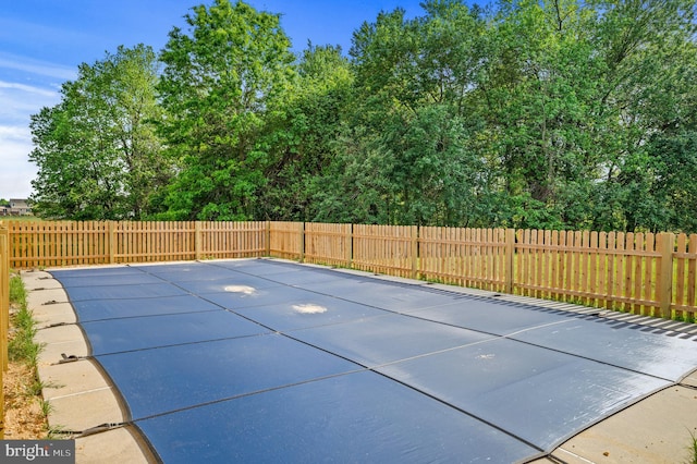 view of swimming pool featuring a fenced backyard