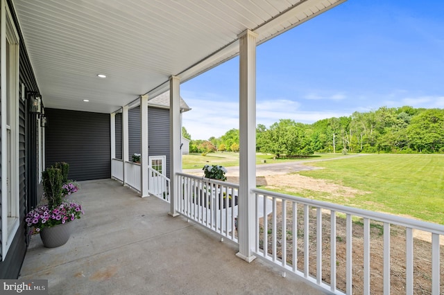 view of patio / terrace with covered porch and a carport