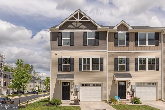 multi unit property featuring an attached garage and concrete driveway