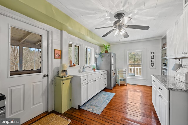 3947 Hebron Valley Rd, Madison, VA 22727 - kitchen with freestanding refrigerator, ceiling fan, wood-type flooring, and white cabinetry