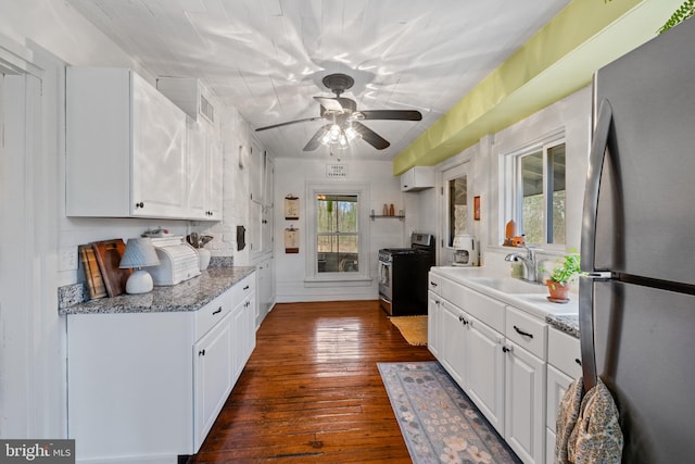 3947 Hebron Valley Rd, Madison, VA 22727 - kitchen featuring stainless steel appliances, white cabinets, a ceiling fan, dark wood finished floors, and a sink