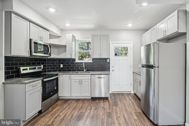 3109 W Arizona St, Philadelphia, PA 19132 - kitchen featuring appliances with stainless steel finishes, a sink, open shelves, dark wood finished floors, and decorative backsplash