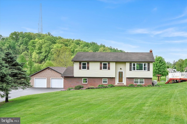191 Meadow Dr, Mohrsville, PA 19541 - bi-level home featuring driveway, a front yard, a chimney, and a garage