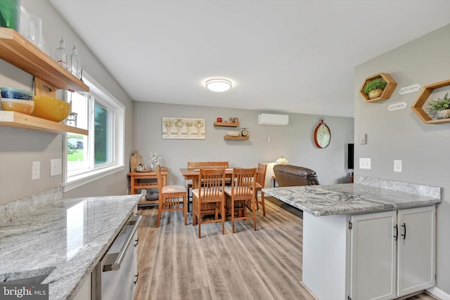 191 Meadow Dr, Mohrsville, PA 19541 - dining room with light wood-type flooring and a wall unit AC