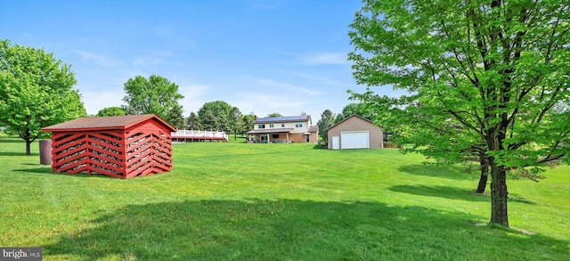 191 Meadow Dr, Mohrsville, PA 19541 - view of green lawn featuring a detached garage and an outdoor structure