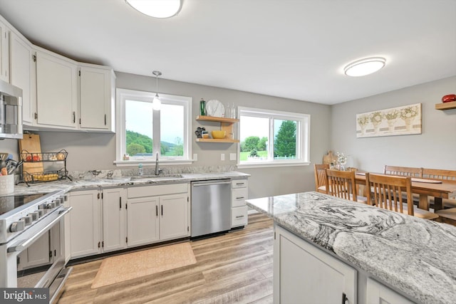191 Meadow Dr, Mohrsville, PA 19541 - kitchen featuring stainless steel appliances, a sink, light wood-type flooring, light stone countertops, and white cabinetry