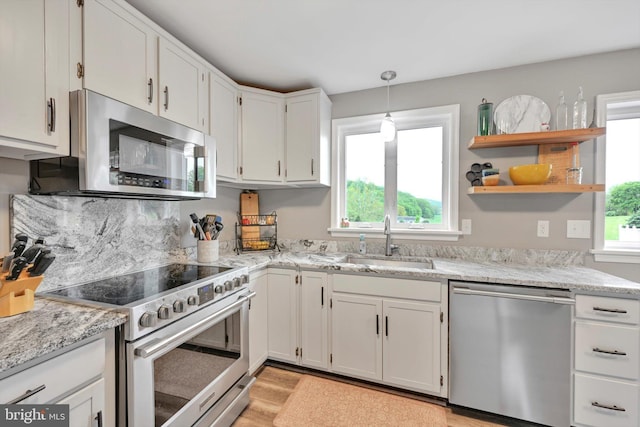 191 Meadow Dr, Mohrsville, PA 19541 - kitchen with appliances with stainless steel finishes, a sink, light wood-type flooring, white cabinetry, and light stone counters