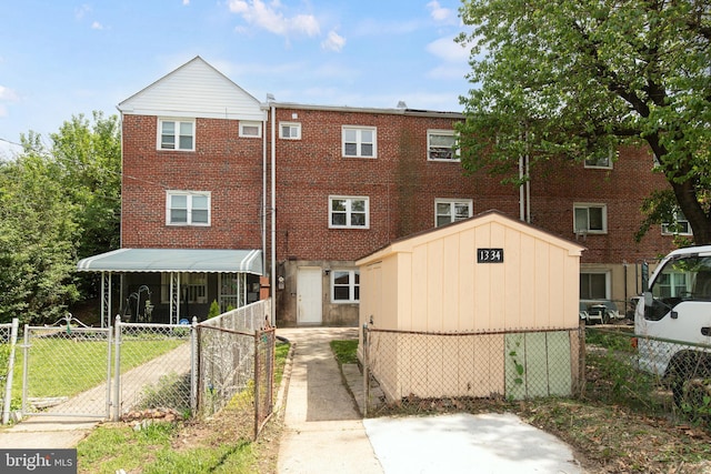 1334 Dalton Rd, Baltimore, MD 21234 - view of front of house with fence, a shed, brick siding, and an outbuilding