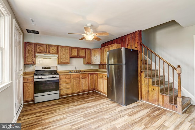 1334 Dalton Rd, Baltimore, MD 21234 - kitchen with stainless steel appliances, under cabinet range hood, light wood finished floors, and a sink