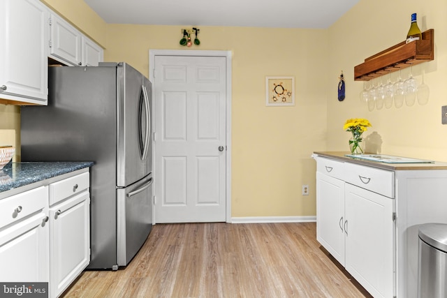 603 Admiral Dr Unit 204, Annapolis, MD 21401 - kitchen with freestanding refrigerator, light wood-type flooring, white cabinetry, dark countertops, and baseboards