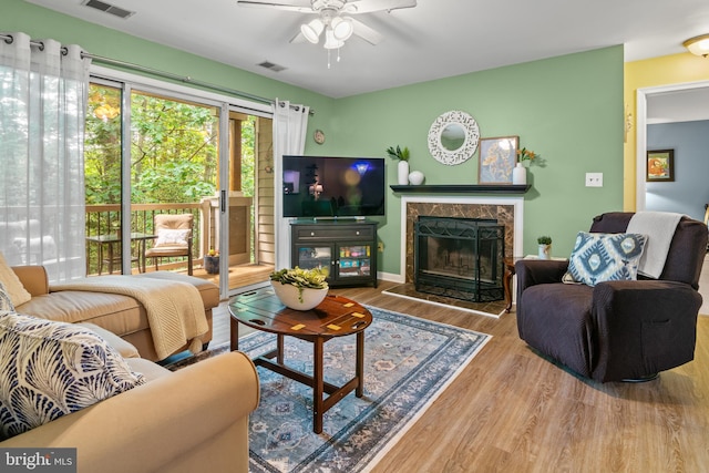 603 Admiral Dr Unit 204, Annapolis, MD 21401 - living area featuring a ceiling fan, wood finished floors, a fireplace, and baseboards
