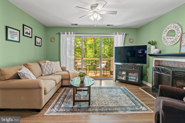 603 Admiral Dr Unit 204, Annapolis, MD 21401 - living room featuring ceiling fan, wood finished floors, a fireplace, and baseboards