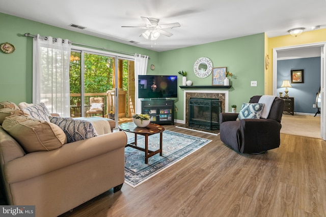 603 Admiral Dr Unit 204, Annapolis, MD 21401 - living room featuring a ceiling fan, baseboards, a high end fireplace, and wood finished floors
