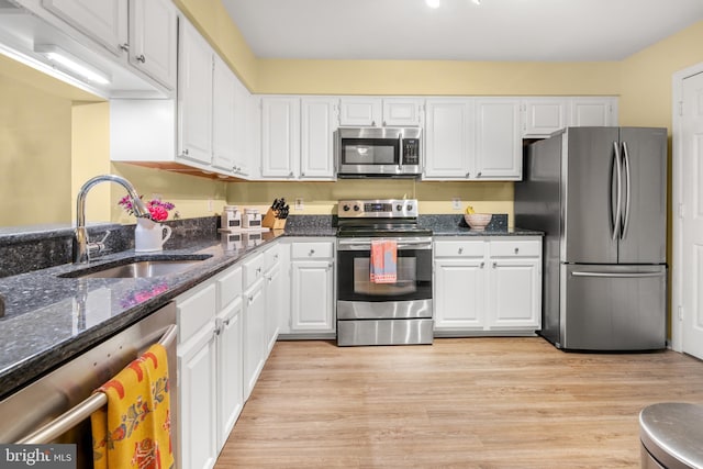 603 Admiral Dr Unit 204, Annapolis, MD 21401 - kitchen featuring appliances with stainless steel finishes, a sink, white cabinetry, and dark stone countertops