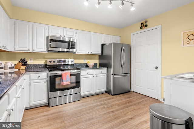 603 Admiral Dr Unit 204, Annapolis, MD 21401 - kitchen with appliances with stainless steel finishes, white cabinets, light wood-style flooring, and dark stone countertops