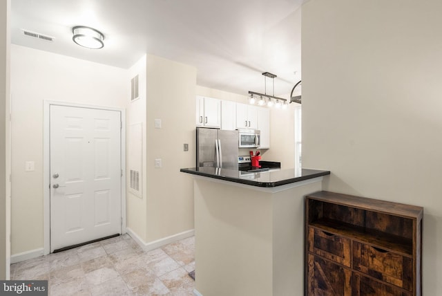 42432 Hollyhock Ter Unit 101, Brambleton, VA 20148 - kitchen featuring stainless steel appliances, dark countertops, white cabinets, baseboards, and decorative light fixtures