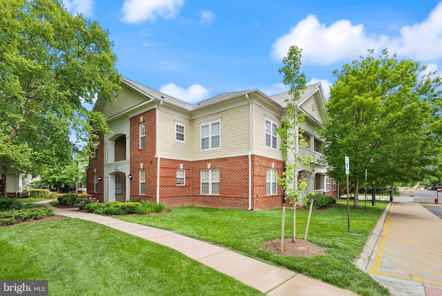42432 Hollyhock Ter Unit 101, Brambleton, VA 20148 - view of front of property with brick siding and a front lawn