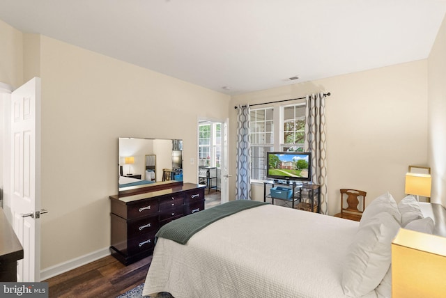 42432 Hollyhock Ter Unit 101, Brambleton, VA 20148 - bedroom featuring dark wood-type flooring and baseboards