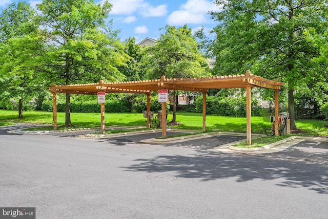 42432 Hollyhock Ter Unit 101, Brambleton, VA 20148 - view of property's community featuring a yard, a pergola, and covered parking