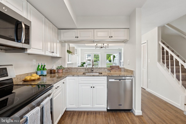 3316 Lakeside View Dr Unit 3-7, Falls Church, VA 22041 - kitchen with appliances with stainless steel finishes, a sink, dark wood-style flooring, white cabinetry, and light stone countertops