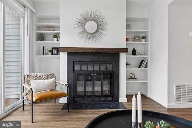 3316 Lakeside View Dr Unit 3-7, Falls Church, VA 22041 - sitting room featuring a fireplace with flush hearth, wood finished floors, built in features, and baseboards