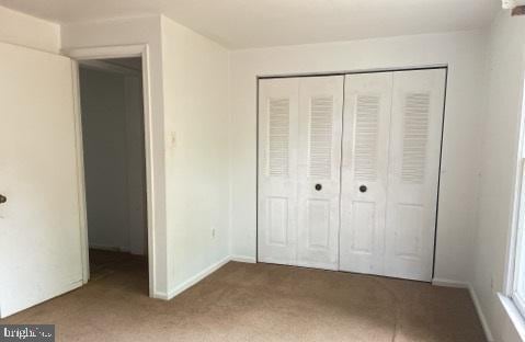 3365 Arundel On The Bay Rd, Annapolis, MD 21403 - unfurnished bedroom featuring carpet floors, a closet, and baseboards