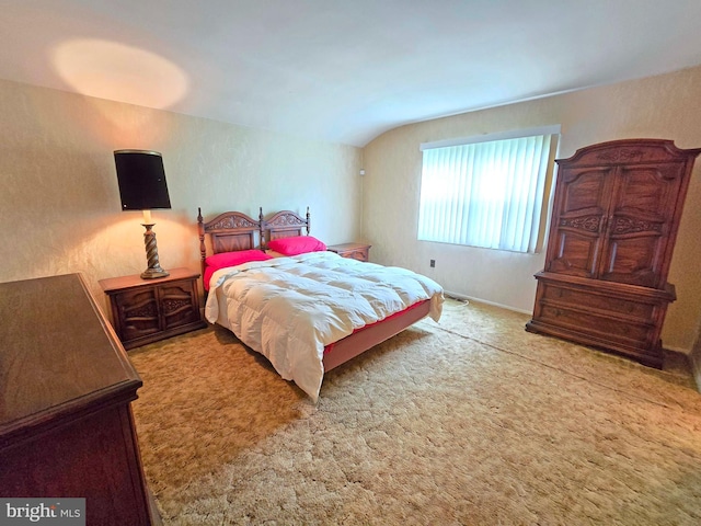 carpeted bedroom with vaulted ceiling