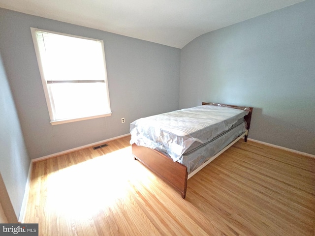 bedroom featuring wood finished floors and baseboards