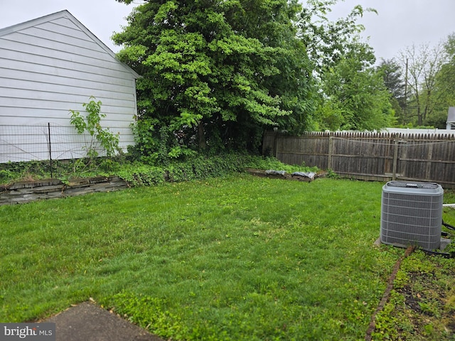 view of yard featuring central air condition unit