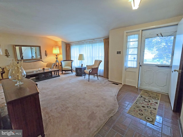 foyer featuring brick patterned floors