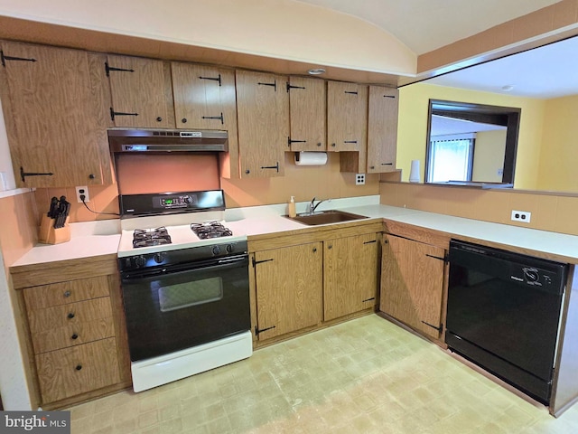 kitchen featuring gas stove, under cabinet range hood, a sink, dishwasher, and light countertops