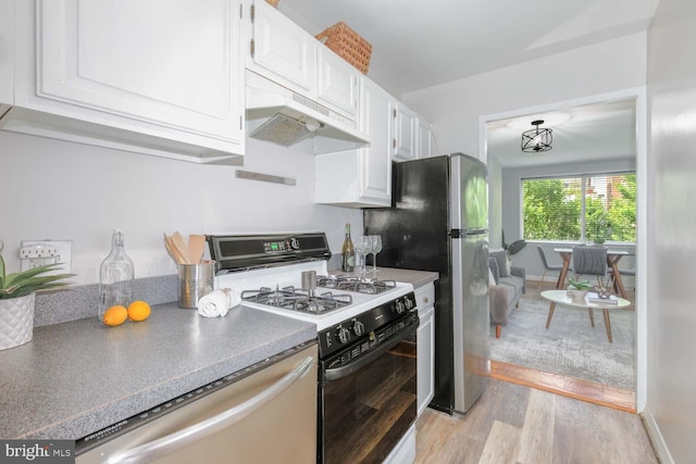 2829 Connecticut Ave NW Unit 312, Washington, DC 20008 - kitchen with gas range oven, dishwasher, under cabinet range hood, white cabinets, and light wood-type flooring
