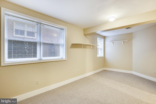 basement featuring baseboards and carpet