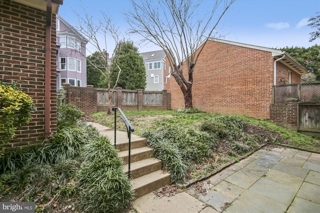 view of yard with fence and a patio area