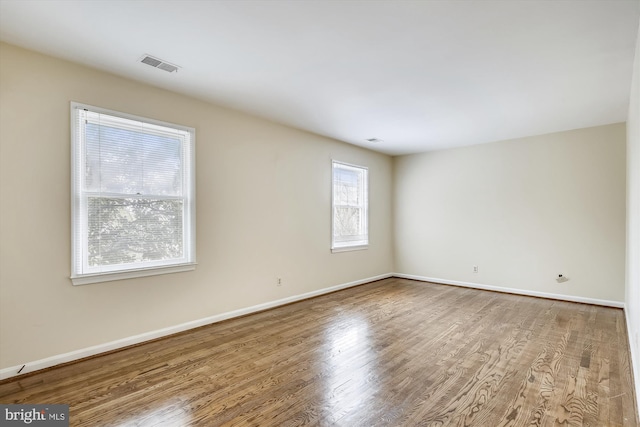 unfurnished room featuring wood finished floors and baseboards